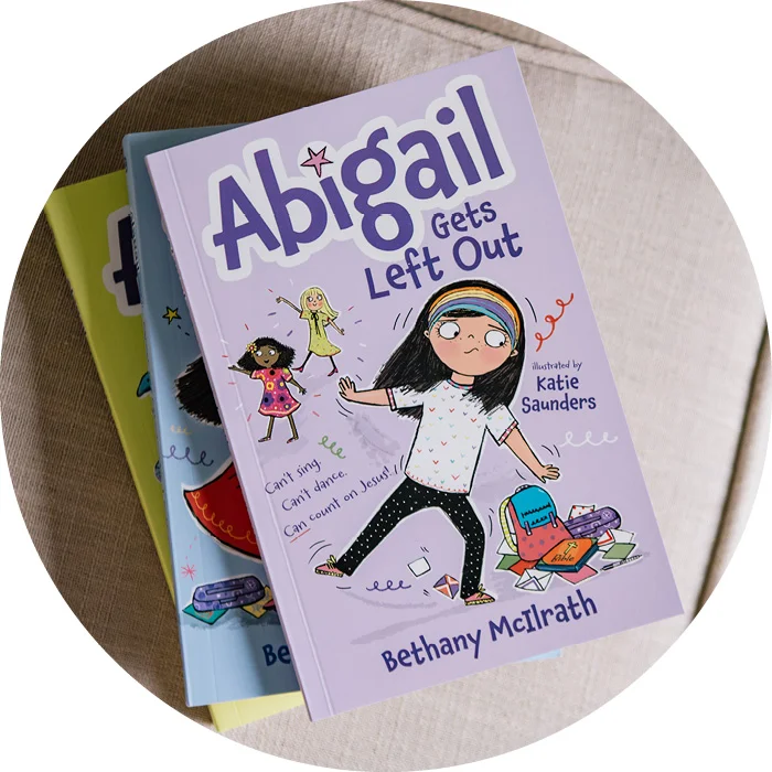 Abigail Gets Left Out on top of a pile of books from the Abigail series