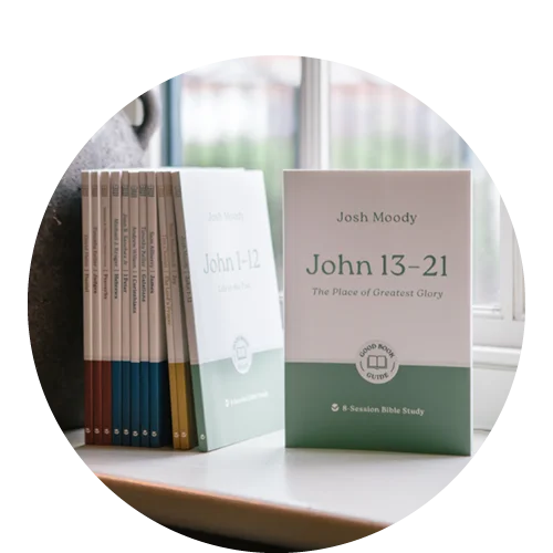 Photograph of John 13-21 Good Book Guide alongside a stack of other books in a window sill