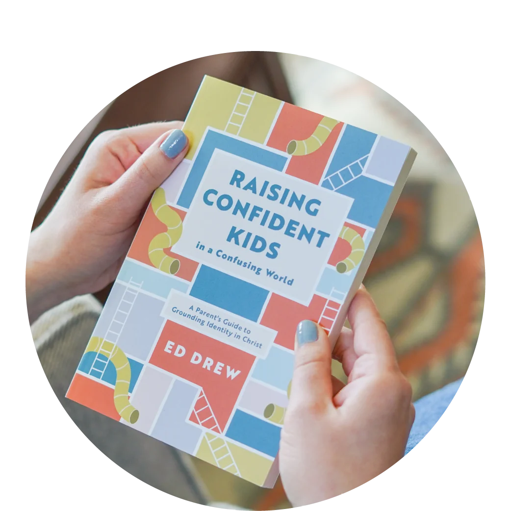 photograph of a person holding Raising Confident Kids in a Confusing World