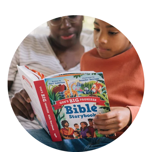 Photograph of a woman reading God's Big Promises Bible Storybook to a small boy
